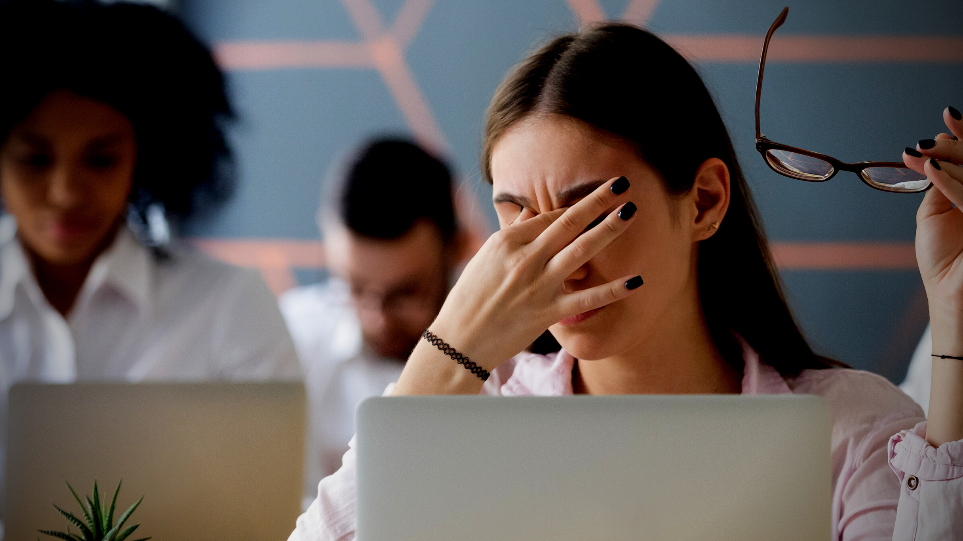 woman rubbing her eyes from computer use - reducing computer screen eye strain